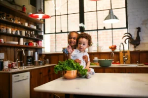 A cozy kitchen with woven placemats, linen curtains, and a patterned runner on a wooden table.