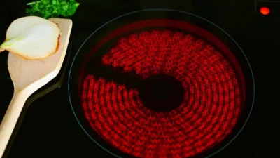 Stylish kitchen shelves decorated with ceramic vases, glass jars, and wooden bowls for a modern rustic look.