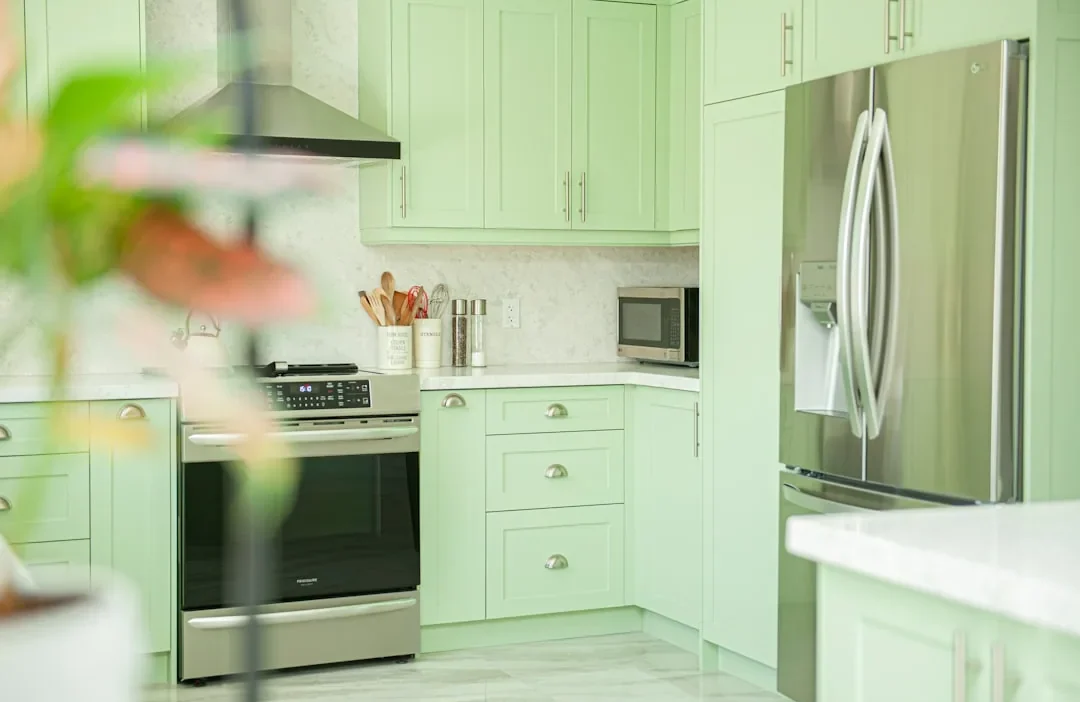 A modern kitchen with updated cabinet hardware, a new faucet, and fresh paint on a budget.