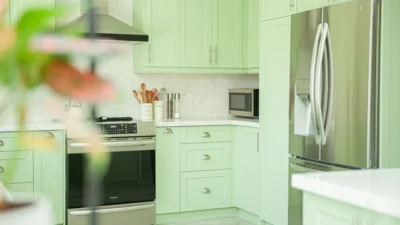 A modern kitchen with updated cabinet hardware, a new faucet, and fresh paint on a budget.