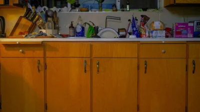A kitchen countertop comparison showing a cluttered side versus a neatly styled, functional side.