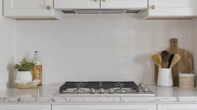 Kitchen cabinet refresh showing new white finish, decorative trim, and balanced hardware placement.
