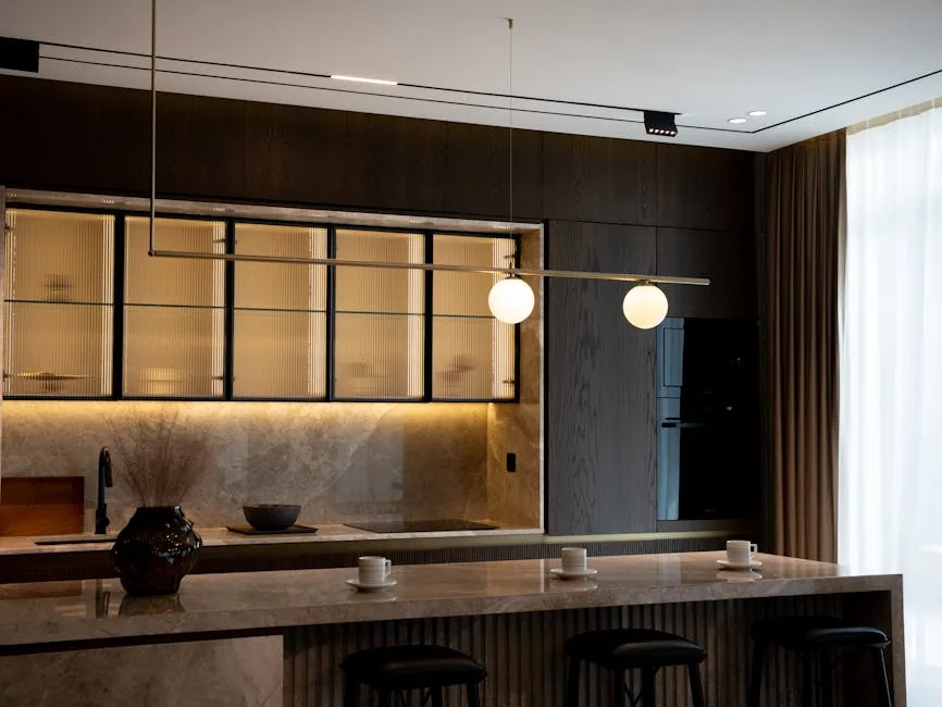 Modern Kitchen With Layered Pendant Lighting And Under-cabinet Lights