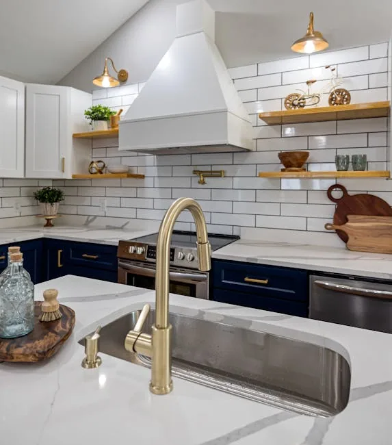 Modern White Kitchen Cabinets With A Mismatched Brass Pendant Light