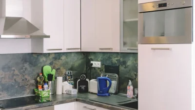 Modern kitchen with updated white shaker cabinets, quartz countertops, and a stylish subway tile backsplash.